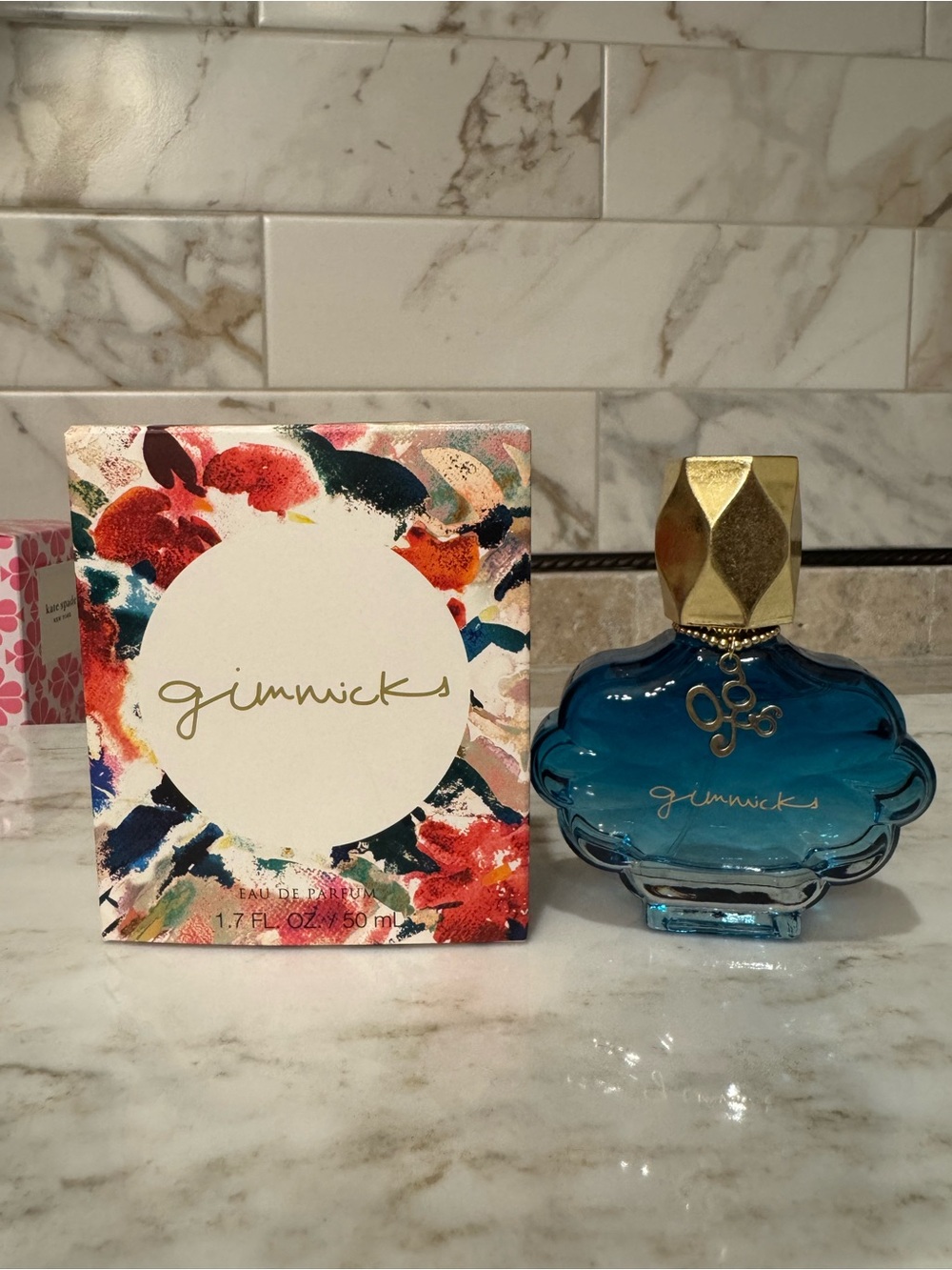 gimmicks by BKE Blue Glass Bottle with Gold Cap Body Oil